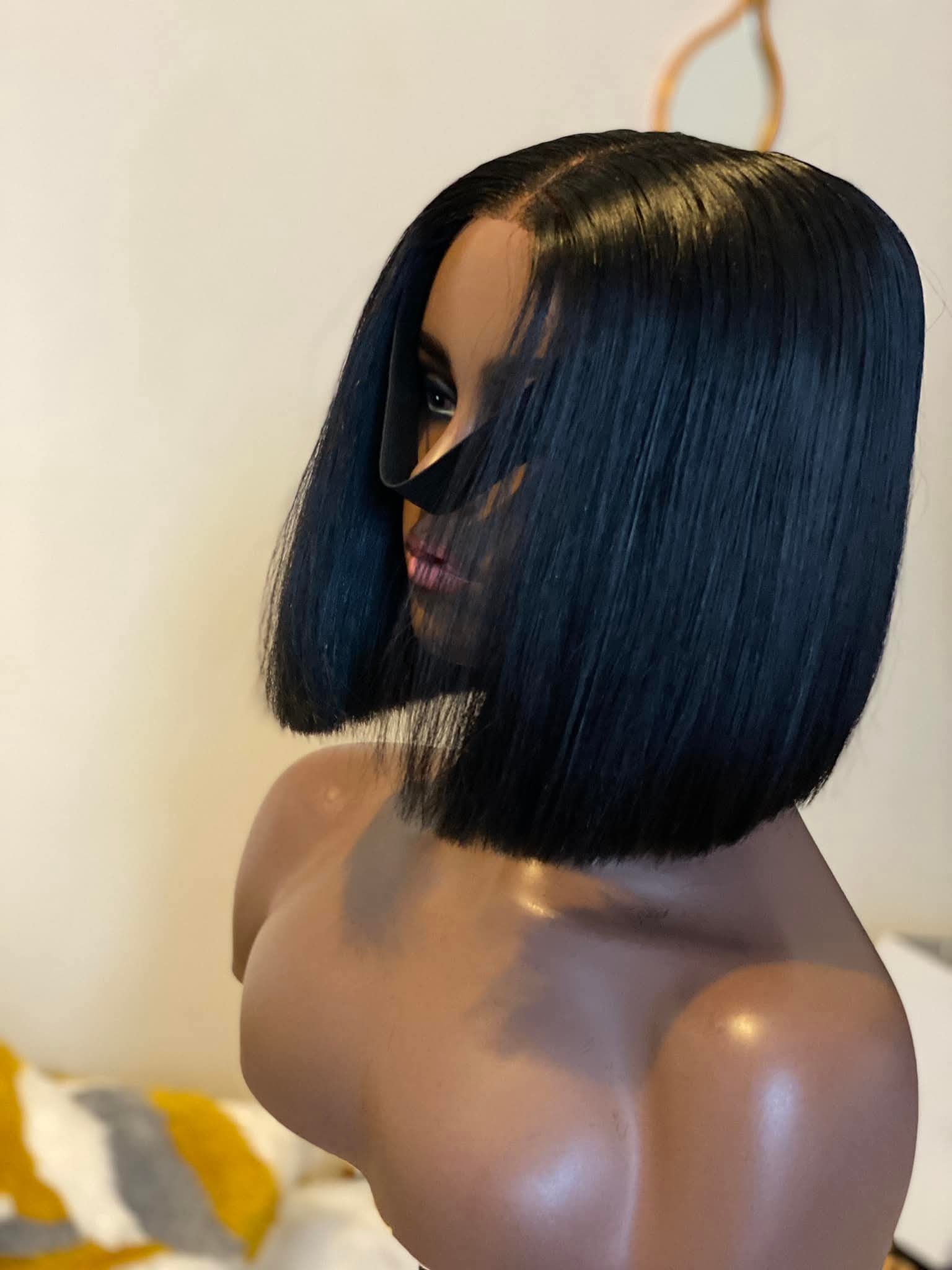 Mannequin head with a blue wig on a neutral background