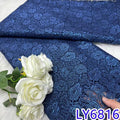 Blue lace fabric with white roses on a light background