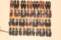 Collection of various sandals displayed on a wooden board.