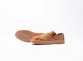 Colorful striped slip-on shoes on a white background