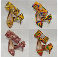 Colorful high-heeled shoes with matching bags on a white background